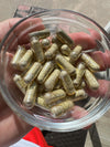 Close-up image of Cerebral Experience's size 00 Ghost Capsules, showcasing their sleek design and color